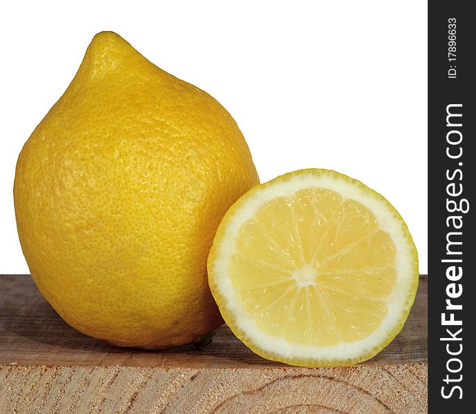 Lemon and the cut off part of a lemon on a background of the cut board. Lemon and the cut off part of a lemon on a background of the cut board