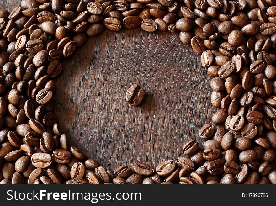 Coffee bean arranged on a wooden table. Coffee bean arranged on a wooden table