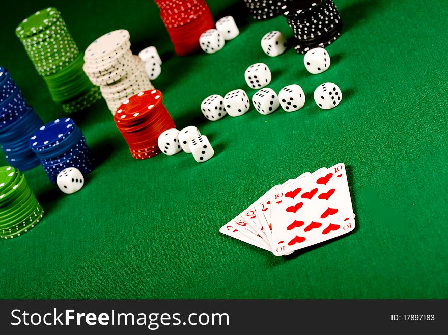 Casino gambling chips and playing cards  on green table. Casino gambling chips and playing cards  on green table