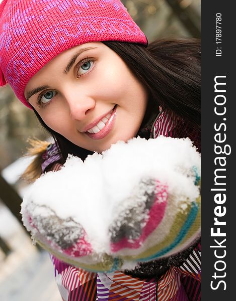 Beautiful young woman outdoor in winter with snow in her hands. Beautiful young woman outdoor in winter with snow in her hands