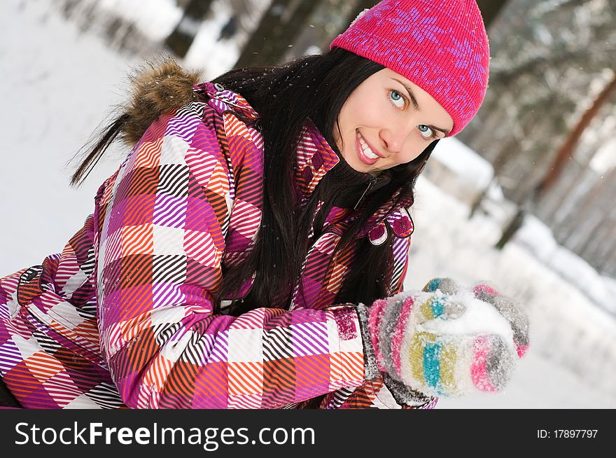 Beautiful young woman outdoor in winter playing with snow. Beautiful young woman outdoor in winter playing with snow