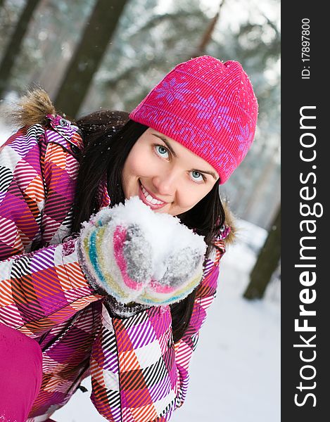 Beautiful young woman outdoor in winter playing with snow. Beautiful young woman outdoor in winter playing with snow