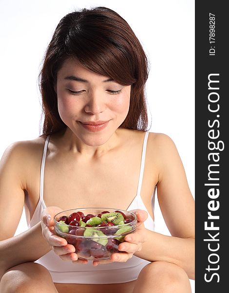 Beautiful japanese woman holding bowl of fruit