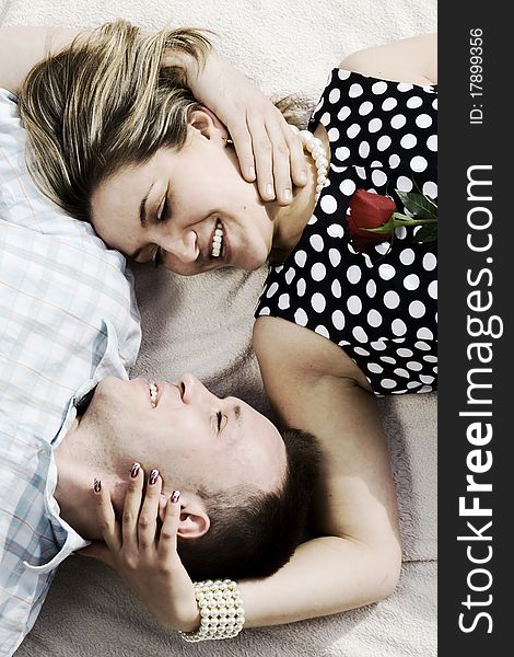 Couple with red rose lying on the blanket. Couple with red rose lying on the blanket