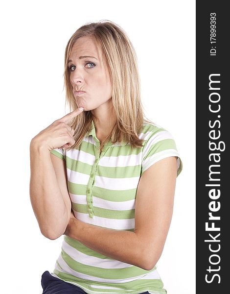 A woman in a green and white striped shirt making a face expression of deep thought. A woman in a green and white striped shirt making a face expression of deep thought.