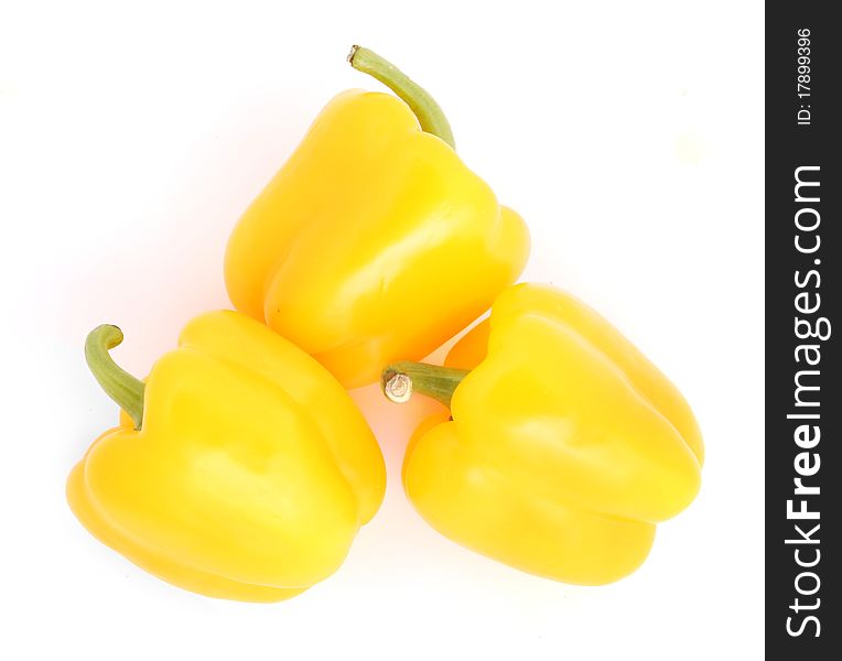 Three yellow peppers on the whitw background