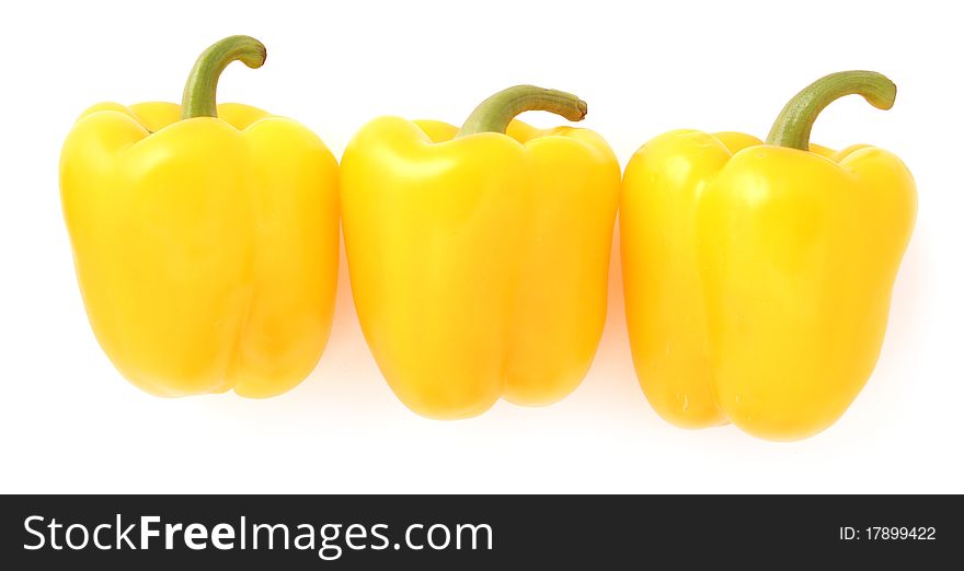 Three yellow peppers on the whitw background