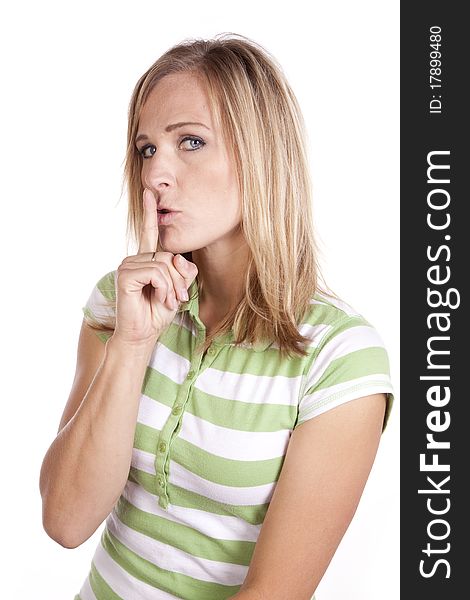 A woman in a green and white striped shirt making a face expression to be quiet. A woman in a green and white striped shirt making a face expression to be quiet.