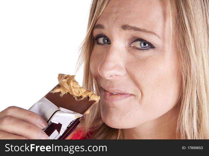 A woman up close with peanut butter on chocolate. A woman up close with peanut butter on chocolate.