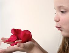 Girl Blowing Rose Petals 2 Stock Photography