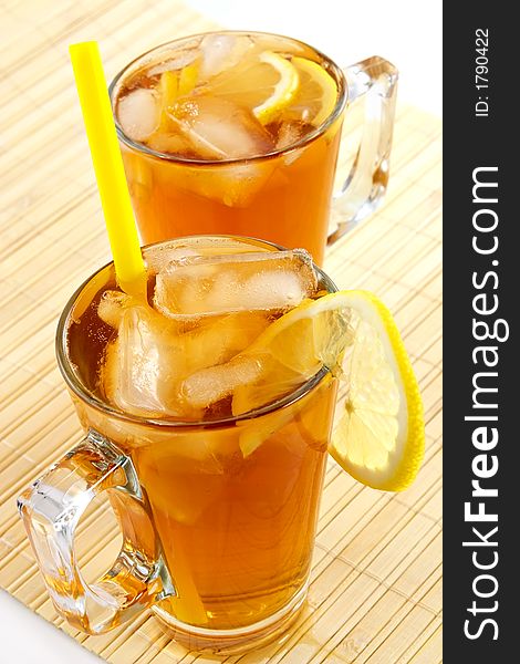 Cold tea with cubes of an ice and a lemon