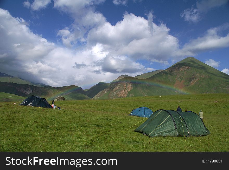 The rainbow in the Caucasian mountains. Summer.