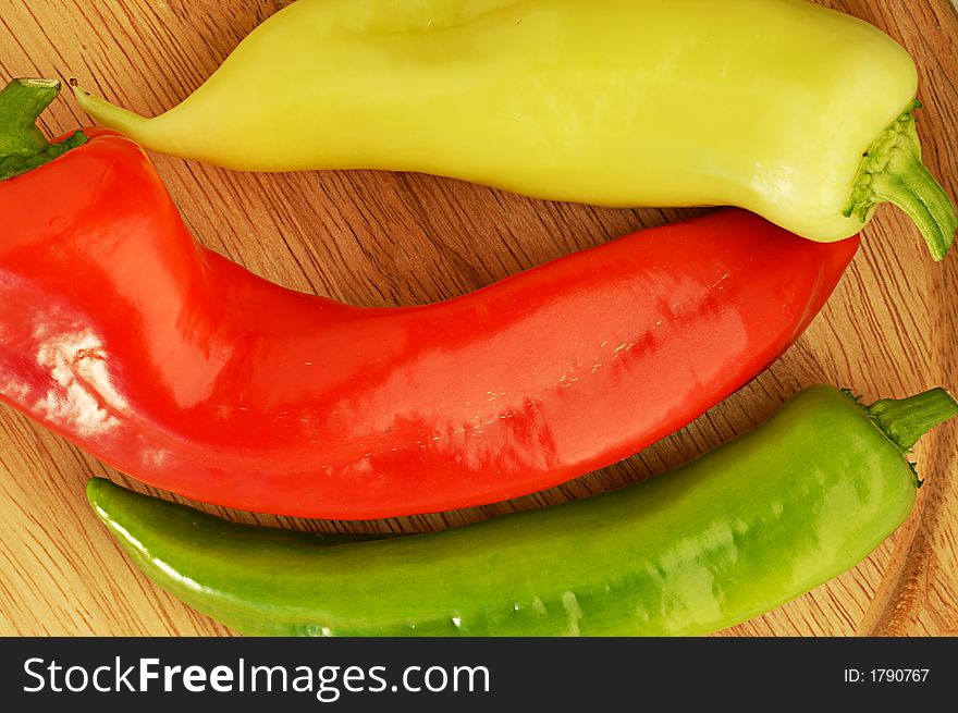 Sweet pepper mix on a wood plate. Sweet pepper mix on a wood plate