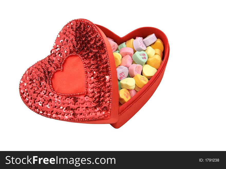 A red heart shaped box filled with Valentines candy.  Isolated with Clipping Path included. A red heart shaped box filled with Valentines candy.  Isolated with Clipping Path included.