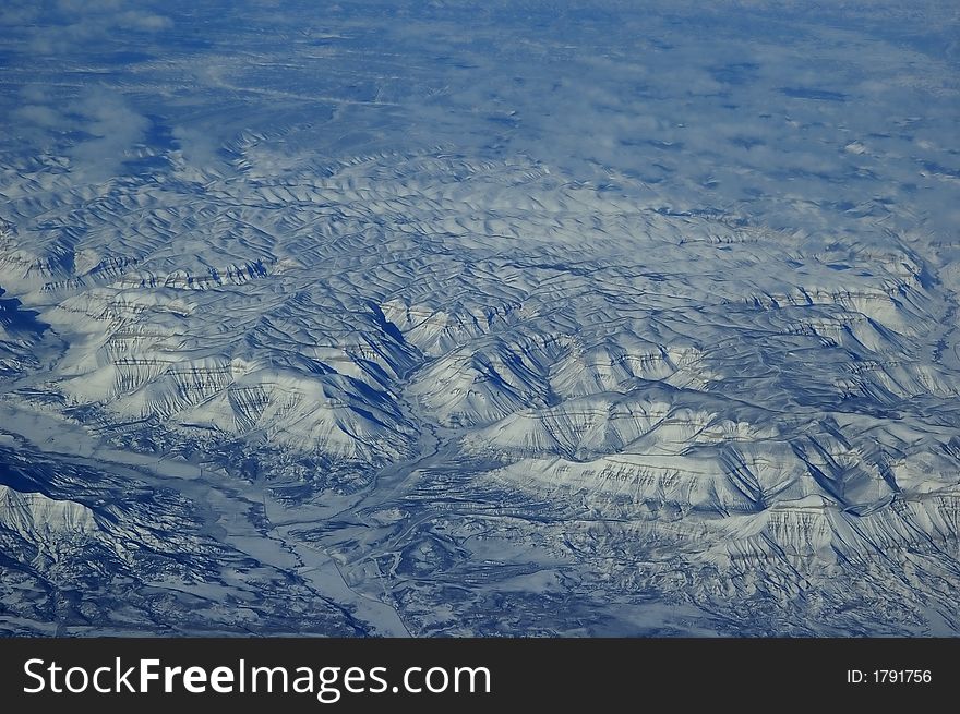 Aerial view of snow clad mountain from the plane. Aerial view of snow clad mountain from the plane