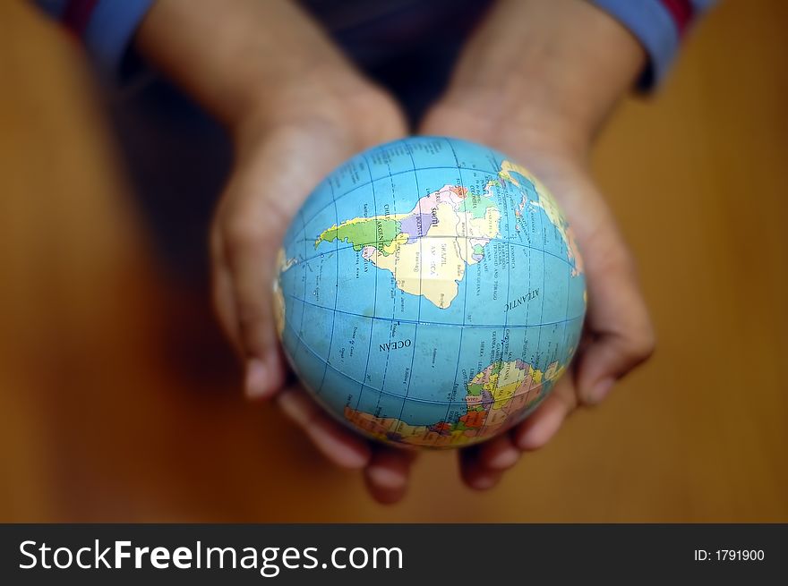 A kid holding a globe in his hands. A kid holding a globe in his hands