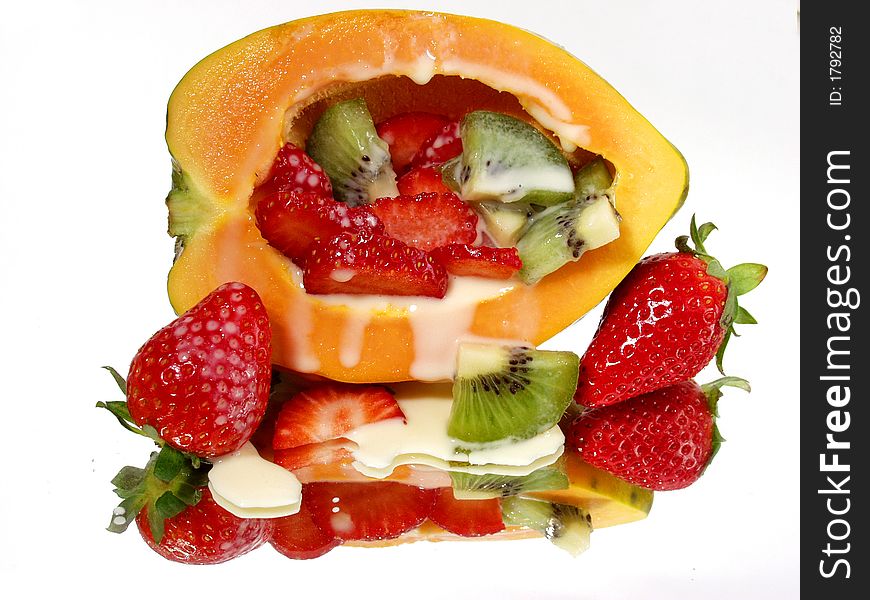 Fresh strawberry and papaya on mirror background with full reflection and cream. Fresh strawberry and papaya on mirror background with full reflection and cream