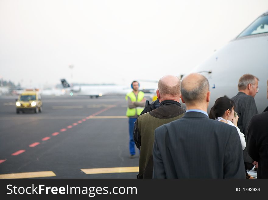 Businesspeople boarding  onto an airplane