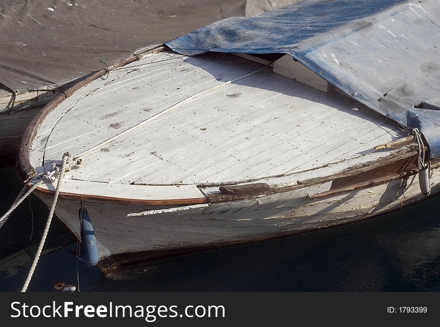 Part of  old wooden boat in small sea port