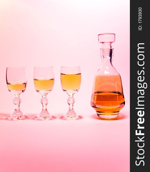Small liqueur-glasses with a bottle alcohol. Small liqueur-glasses with a bottle alcohol