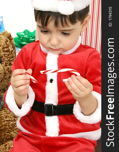 Sad boy in Christmas Suit with broken candy can in hand. Sad boy in Christmas Suit with broken candy can in hand.