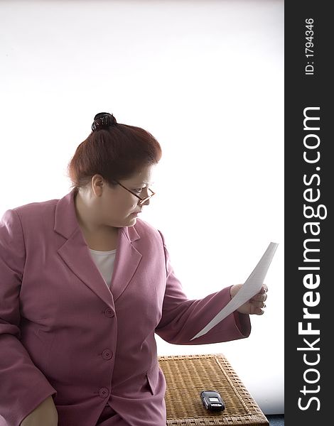 Business woman reading a report. Business woman reading a report