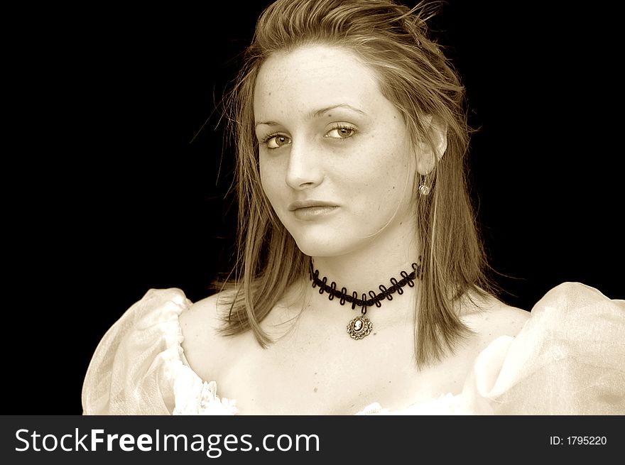 Portrait of a girl in a victorian dress and necklace in sepia. Portrait of a girl in a victorian dress and necklace in sepia