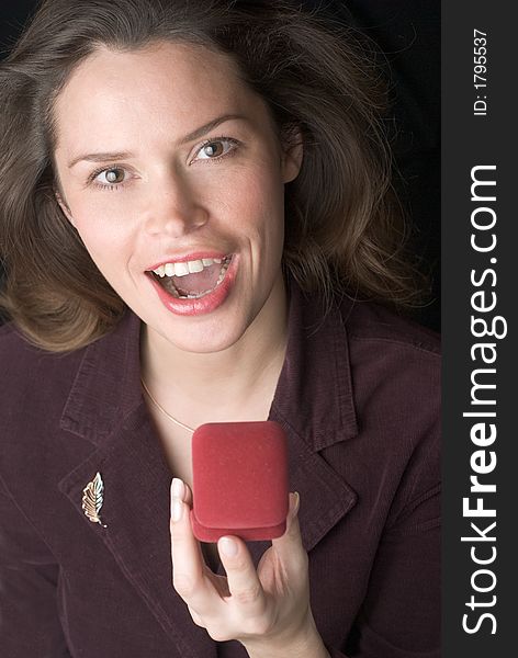 Pretty brunette is very happy to receive a present in a red box