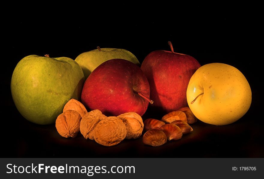 Apple, walnut & chestnut in dark background