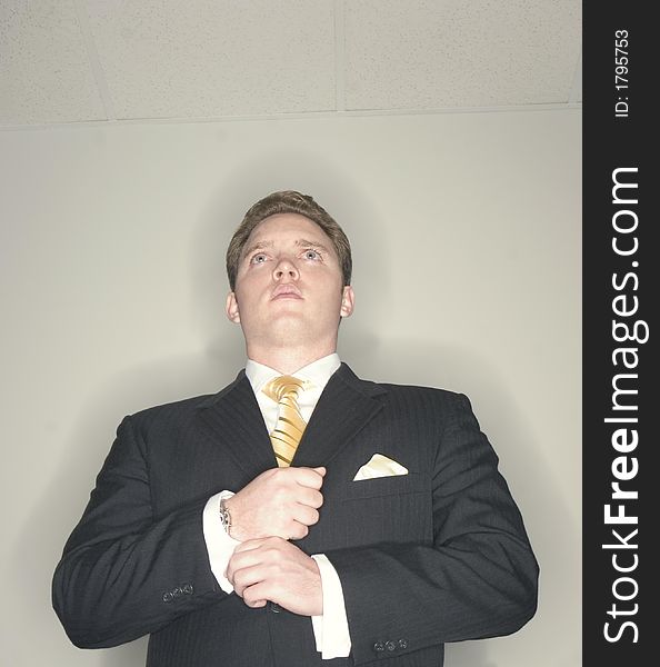 Businessman gets his shirt and cuffs ready in order to move ahead while wearing a black suit and looking forward. Businessman gets his shirt and cuffs ready in order to move ahead while wearing a black suit and looking forward