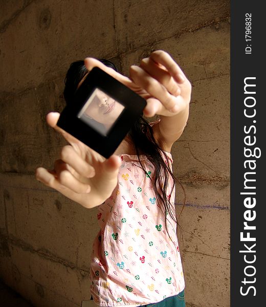 Girl holding slide mount with both hands