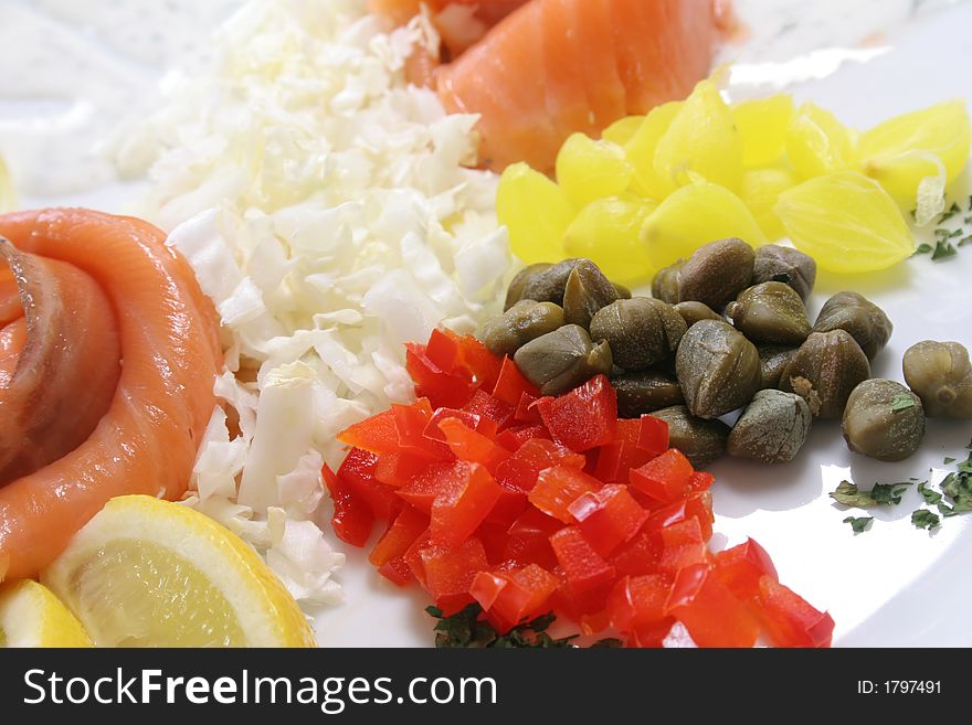 Slices of fresh kipper on the plate with  vegetables