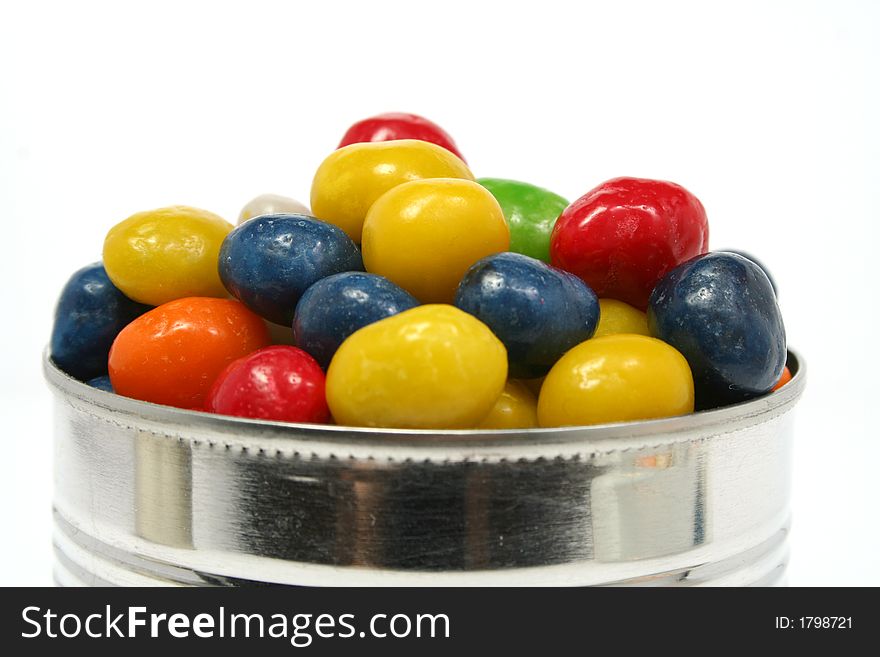 Multi-coloured sweets with raisin in metal bank 2, isolated on white, (look similar images in my portfolio)