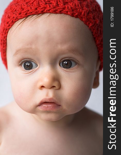 Portrait of 9-month old baby wearing a red cap. Portrait of 9-month old baby wearing a red cap