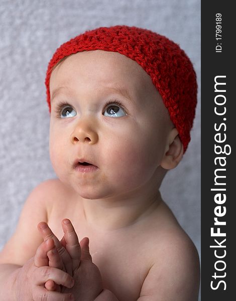 Portrait of 9-month old baby wearing a red cap. Portrait of 9-month old baby wearing a red cap