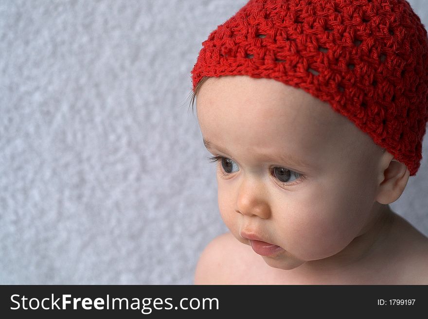 Portrait of 9-month old baby wearing a red cap. Portrait of 9-month old baby wearing a red cap