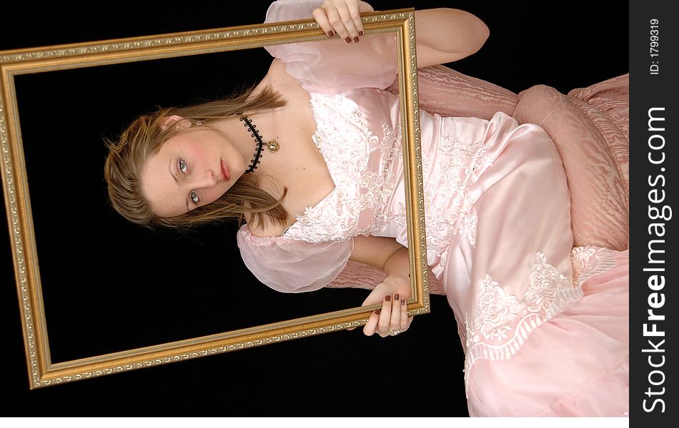 Portrait of a girl in a victorian dress and necklace holding a gold picture frame. Portrait of a girl in a victorian dress and necklace holding a gold picture frame