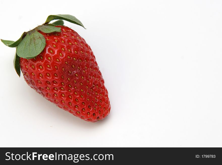 A single strawberry fruit on the white background