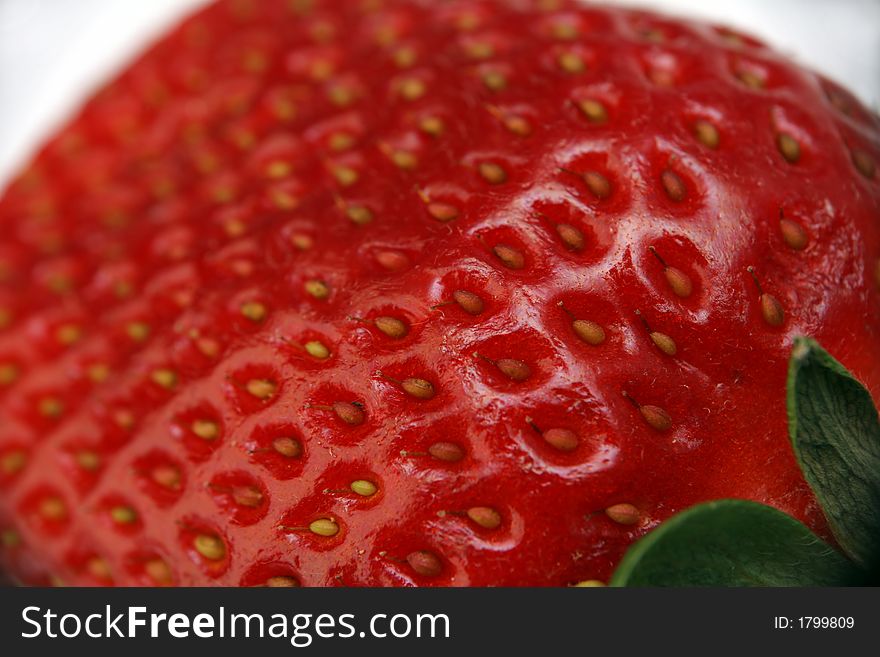 A single strawberry fruit on the background
