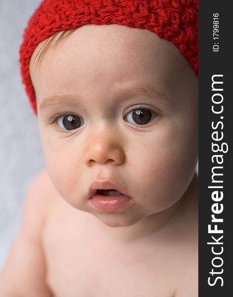 Portrait of 9-month old baby wearing a red cap. Portrait of 9-month old baby wearing a red cap