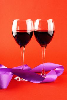 Two Glasses Of Wine On A Red Background. Royalty Free Stock Photography Two Glasses Of Wine On A Red Background. Royalty Free Stock Photography