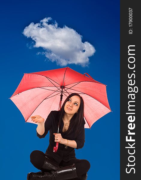 Woman is sitting under a cloud with umbrella looking for rain. Woman is sitting under a cloud with umbrella looking for rain