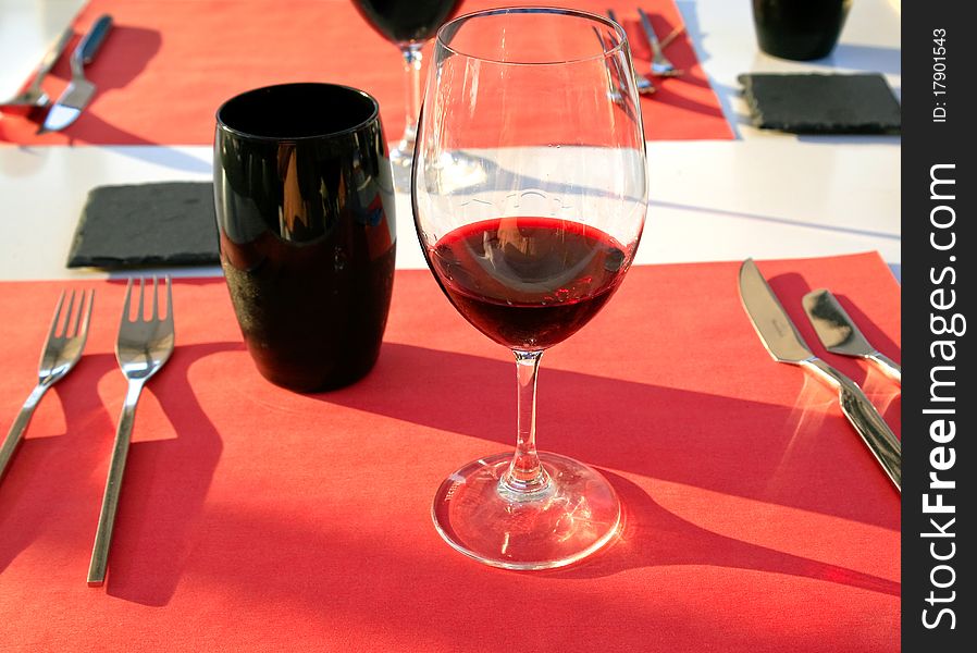 Glass with wine on red tablenapkin. Glass with wine on red tablenapkin