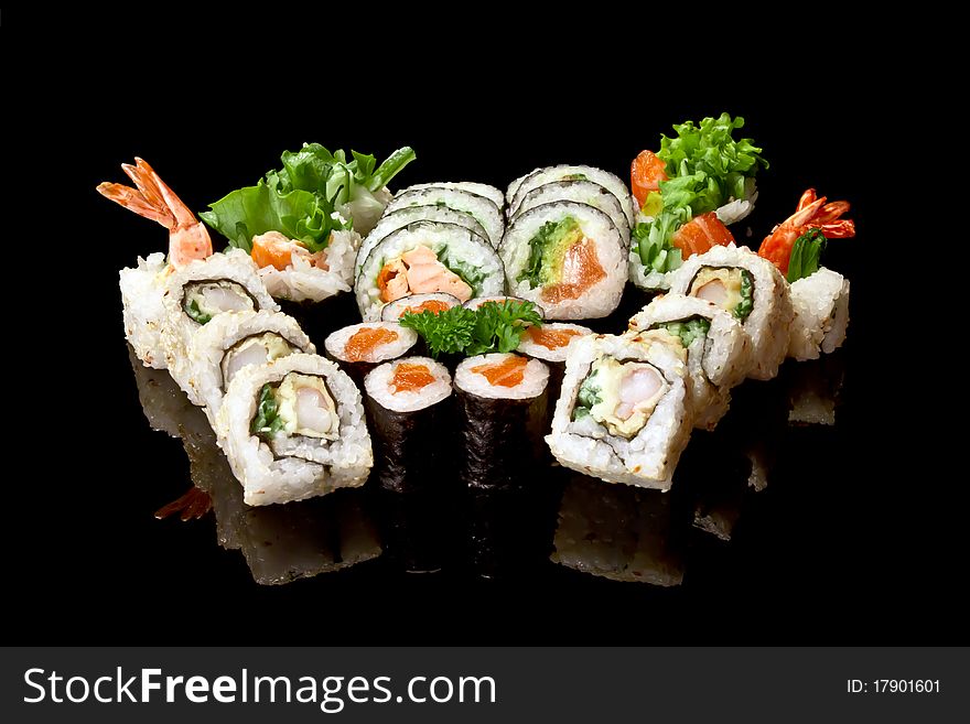 Japanese sushi seafood rolls with rice isolated on black