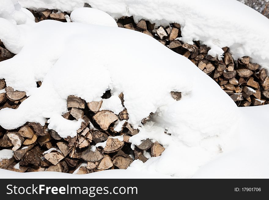 Stacks of firewood covered by snow. Stacks of firewood covered by snow