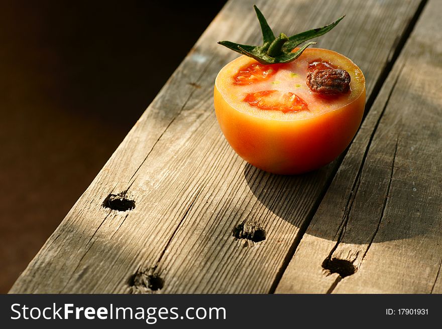 A fresh and juicy tomato on the table. A fresh and juicy tomato on the table