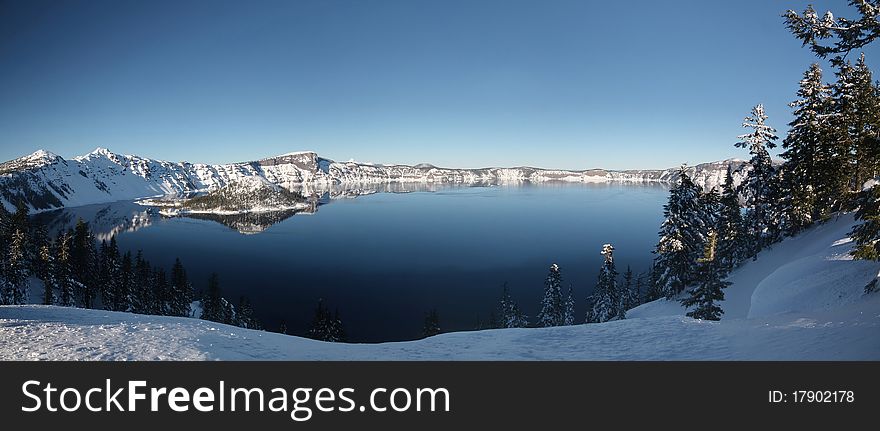 Panoramic picture of Crater Lake in Oregon showing wizard island. Winter day with thick snow. Panoramic picture of Crater Lake in Oregon showing wizard island. Winter day with thick snow