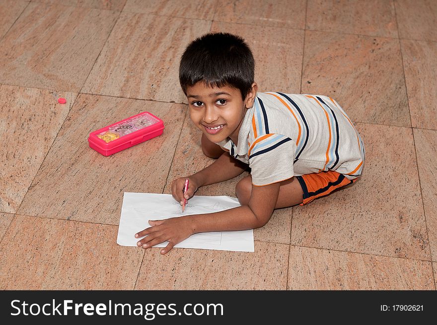 An handsome indian kid doing homework