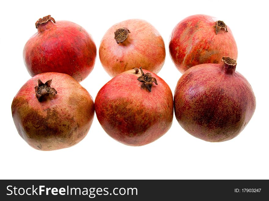 A little red pomegranates lying together on a white background