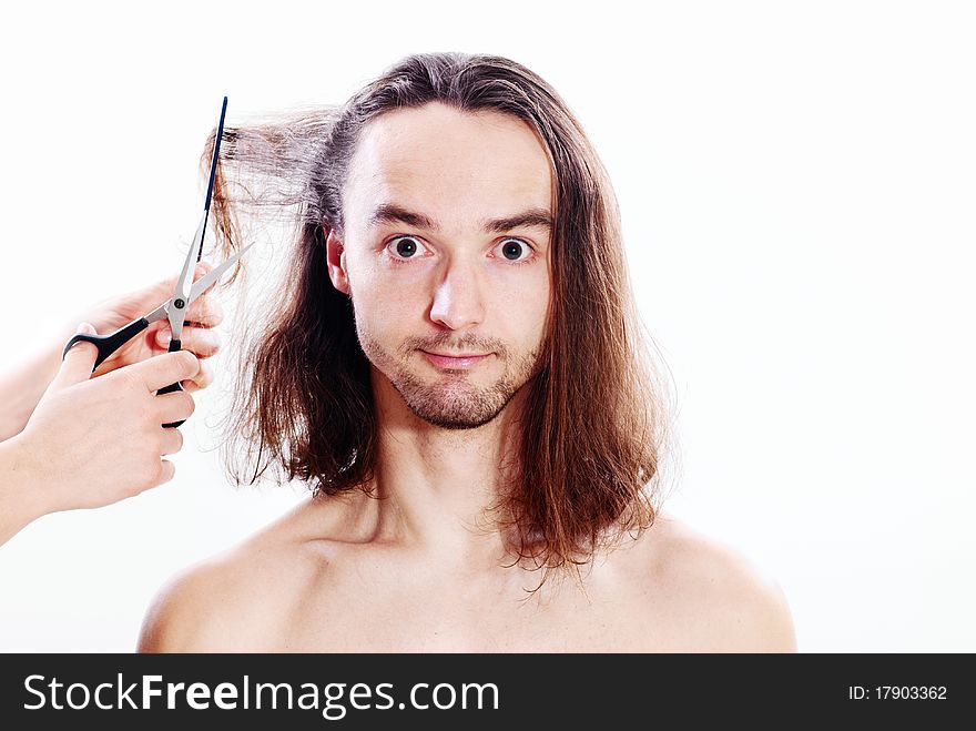 Young joyful man with long hair in barbershop. Young joyful man with long hair in barbershop